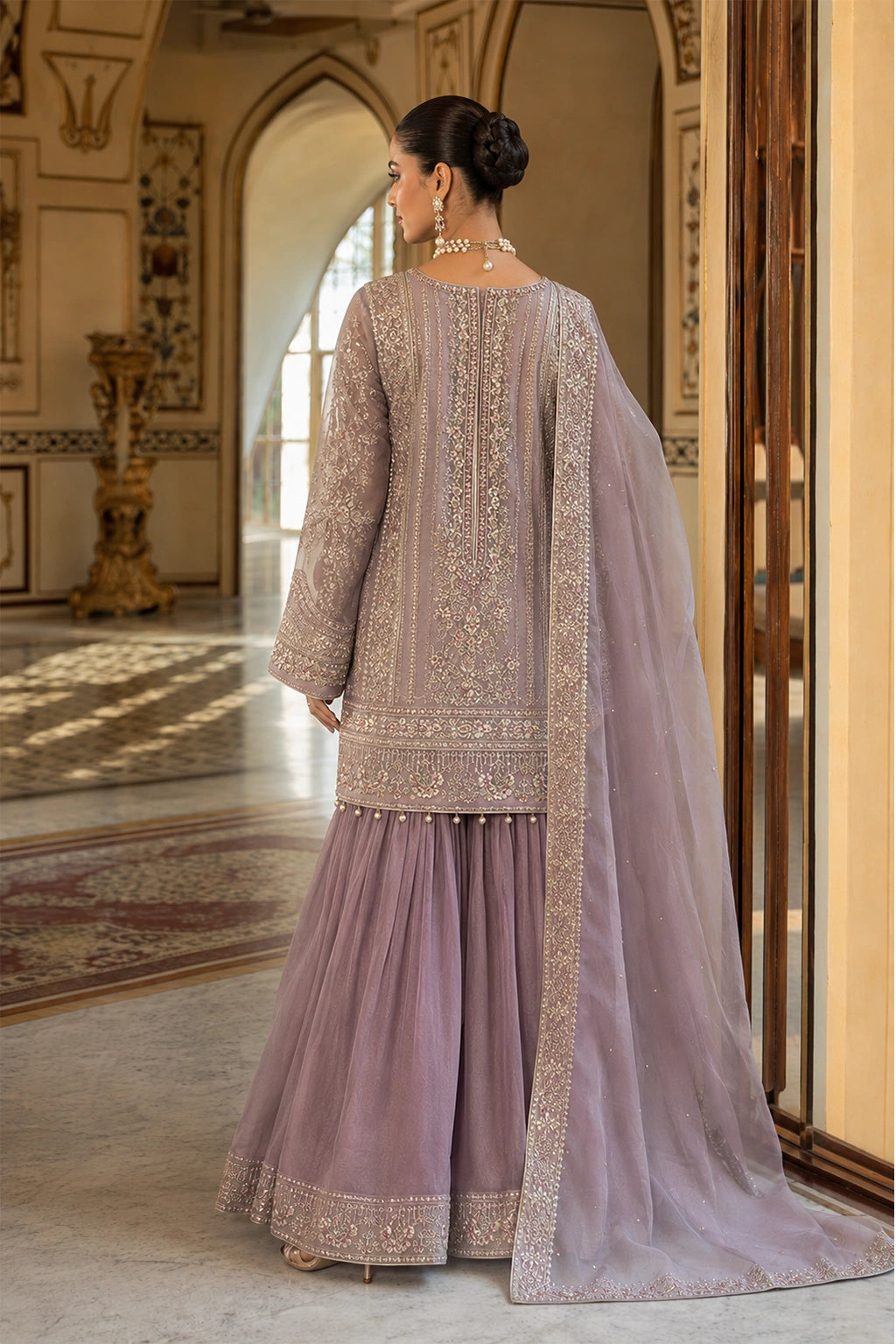 Woman wearing a lilac Korean silk embroidered shirt with organza sharara and embellished organza dupatta by Miraam