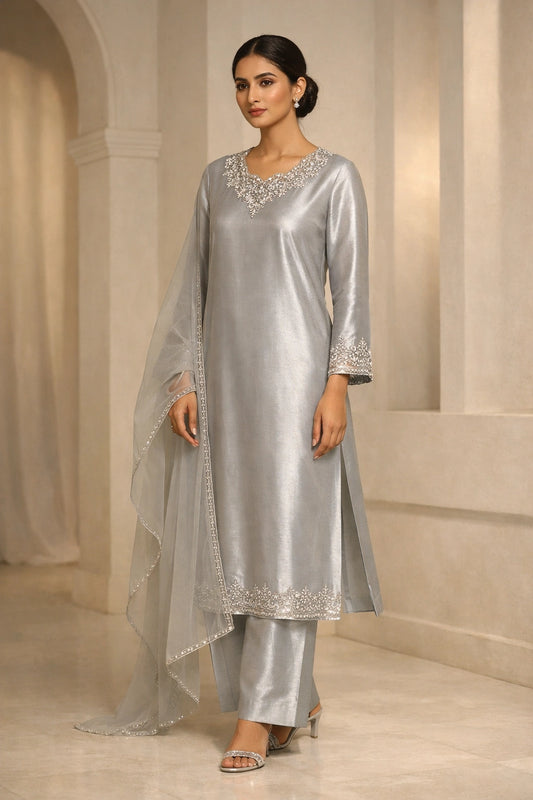 Luxury silver sheesha silk outfit with hand-embellished neckline and sheer dupatta from Miraam’s Noor-e-Sheesha Collection