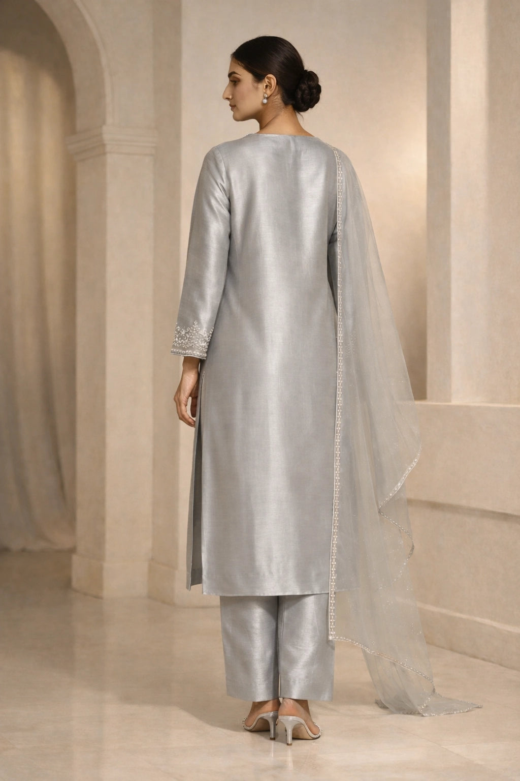 Luxury silver sheesha silk outfit with hand-embellished neckline and sheer dupatta from Miraam’s Noor-e-Sheesha Collection