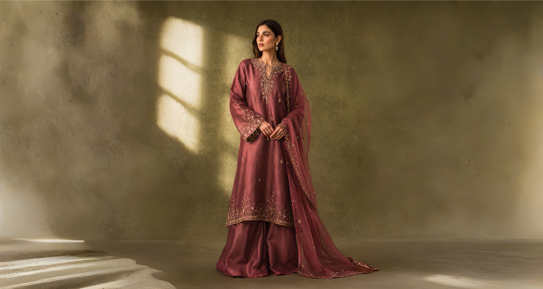 Woman wearing the Roselle Plum Sheesha Silk formal outfit from the Miraam Éclat Lumière Collection with an embroidered organza dupatta.
