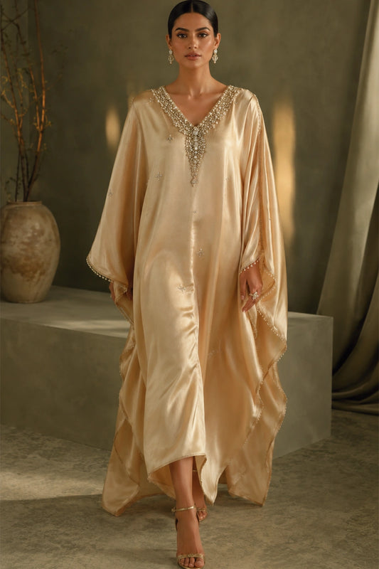 Solène Champagne by Miraam featuring a flowing champagne sheesha silk kaftan with an embellished neckline and elegant draped sleeves.
