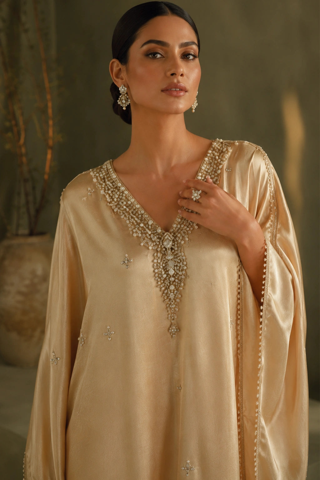 Solène Champagne by Miraam featuring a flowing champagne sheesha silk kaftan with an embellished neckline and elegant draped sleeves.