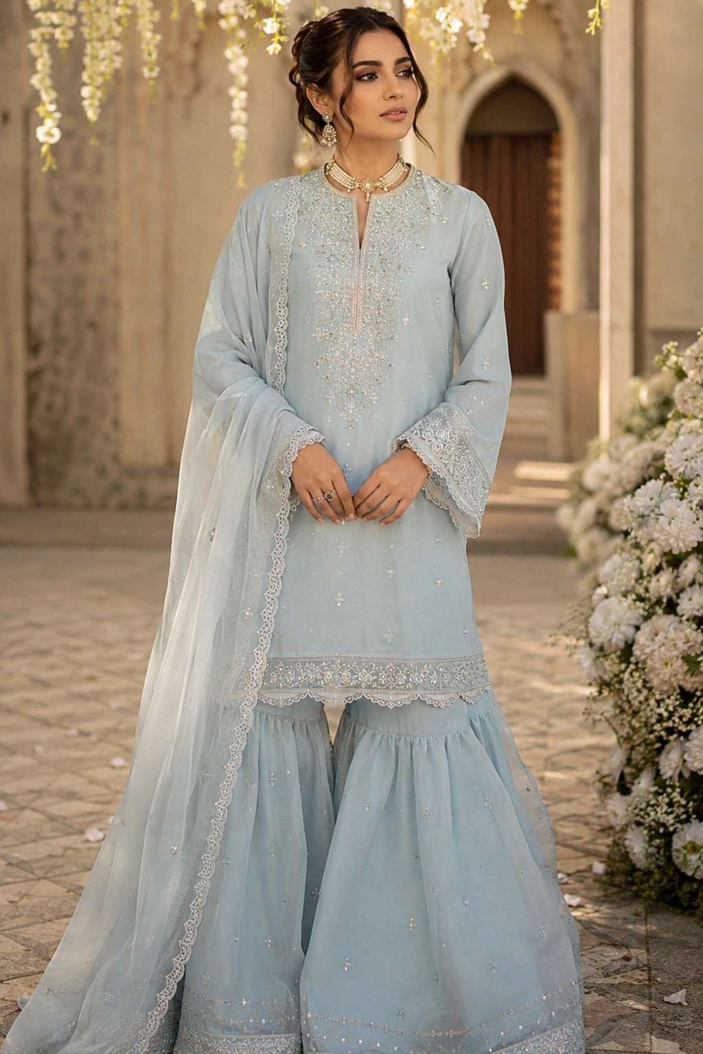 Azzurra Mist luxury powder blue Korean silk formal dress featuring an embroidered straight shirt, flowing chiffon sharara, and embroidered organza dupatta by Miraam.