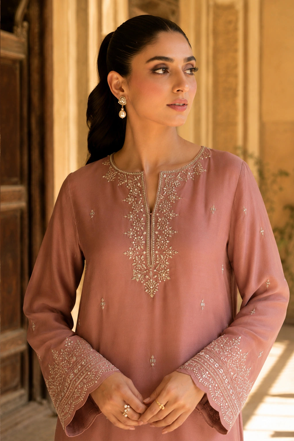Roselune Blush luxury blush pink Korean silk formal dress featuring an embroidered straight shirt, flared trousers, and an embroidered organza dupatta by Miraam.