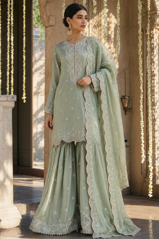 Verdelle Sage luxury sage green Korean silk formal dress featuring embroidered straight shirt, flowing gharara and embroidered organza dupatta by Miraam.