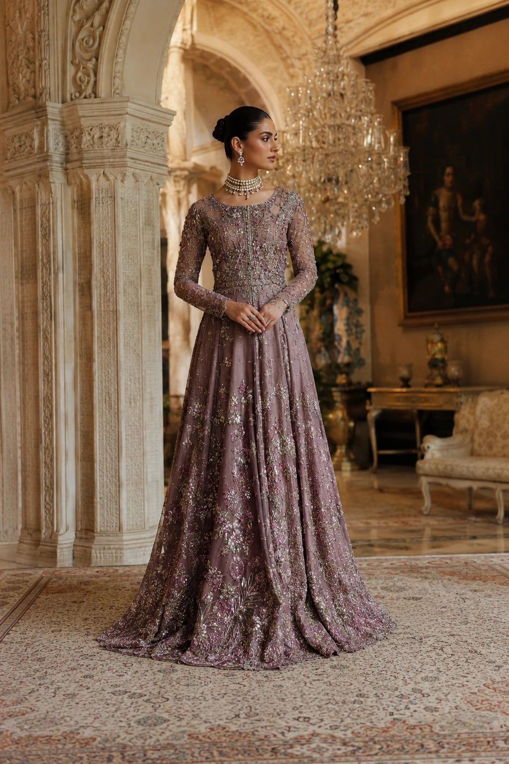 Woman wearing a mauve embellished couture gown with embroidered net sleeves and embellished net dupatta by Miraam