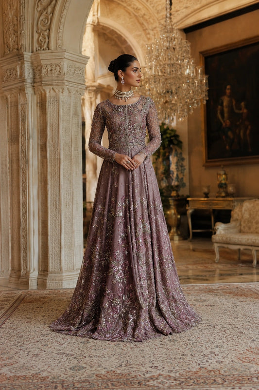 Woman wearing a mauve embellished couture gown with embroidered net sleeves and embellished net dupatta by Miraam