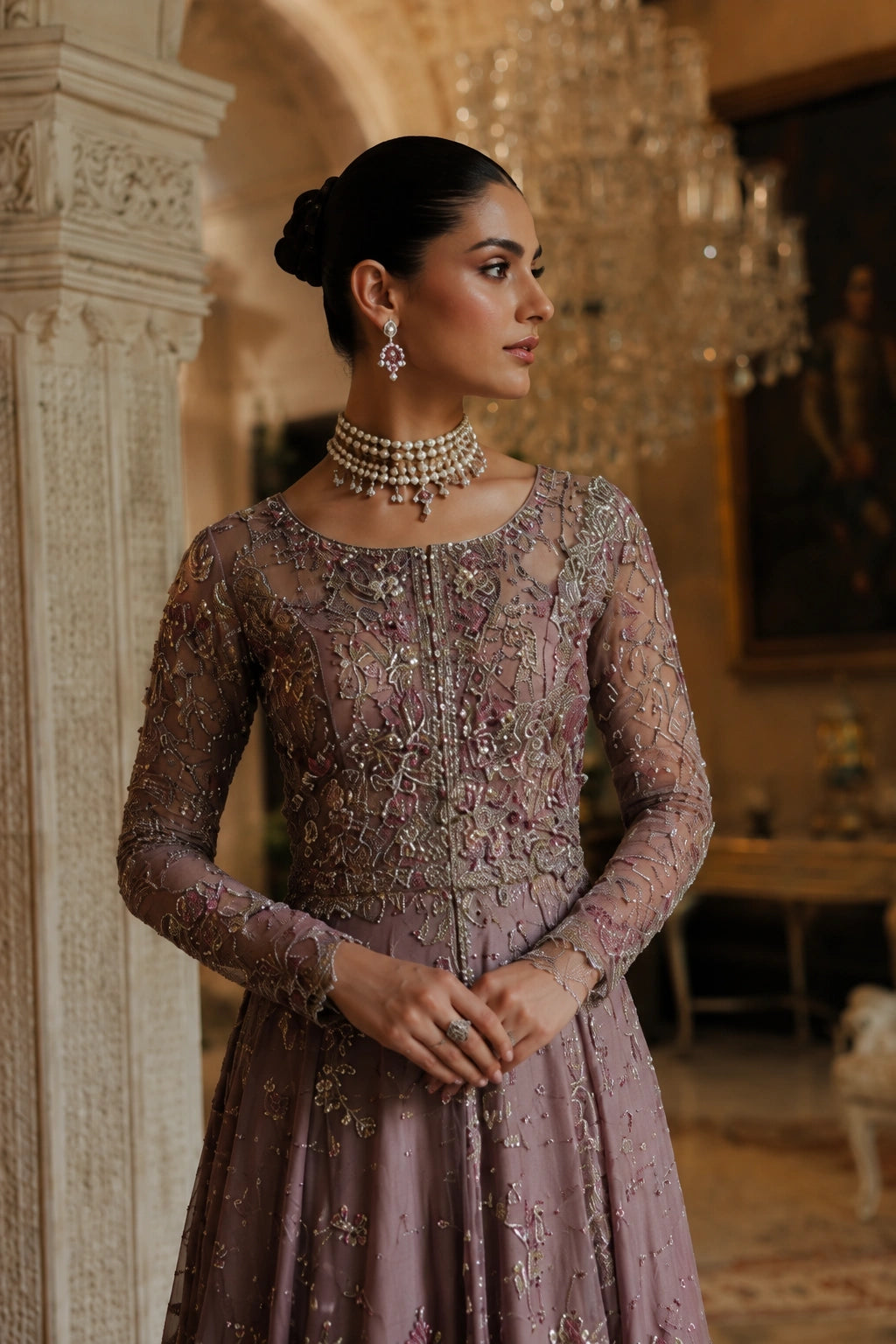Woman wearing a mauve embellished couture gown with embroidered net sleeves and embellished net dupatta by Miraam