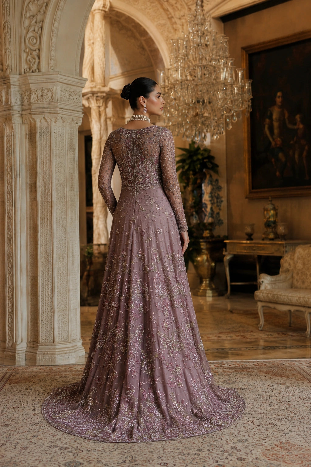 Woman wearing a mauve embellished couture gown with embroidered net sleeves and embellished net dupatta by Miraam
