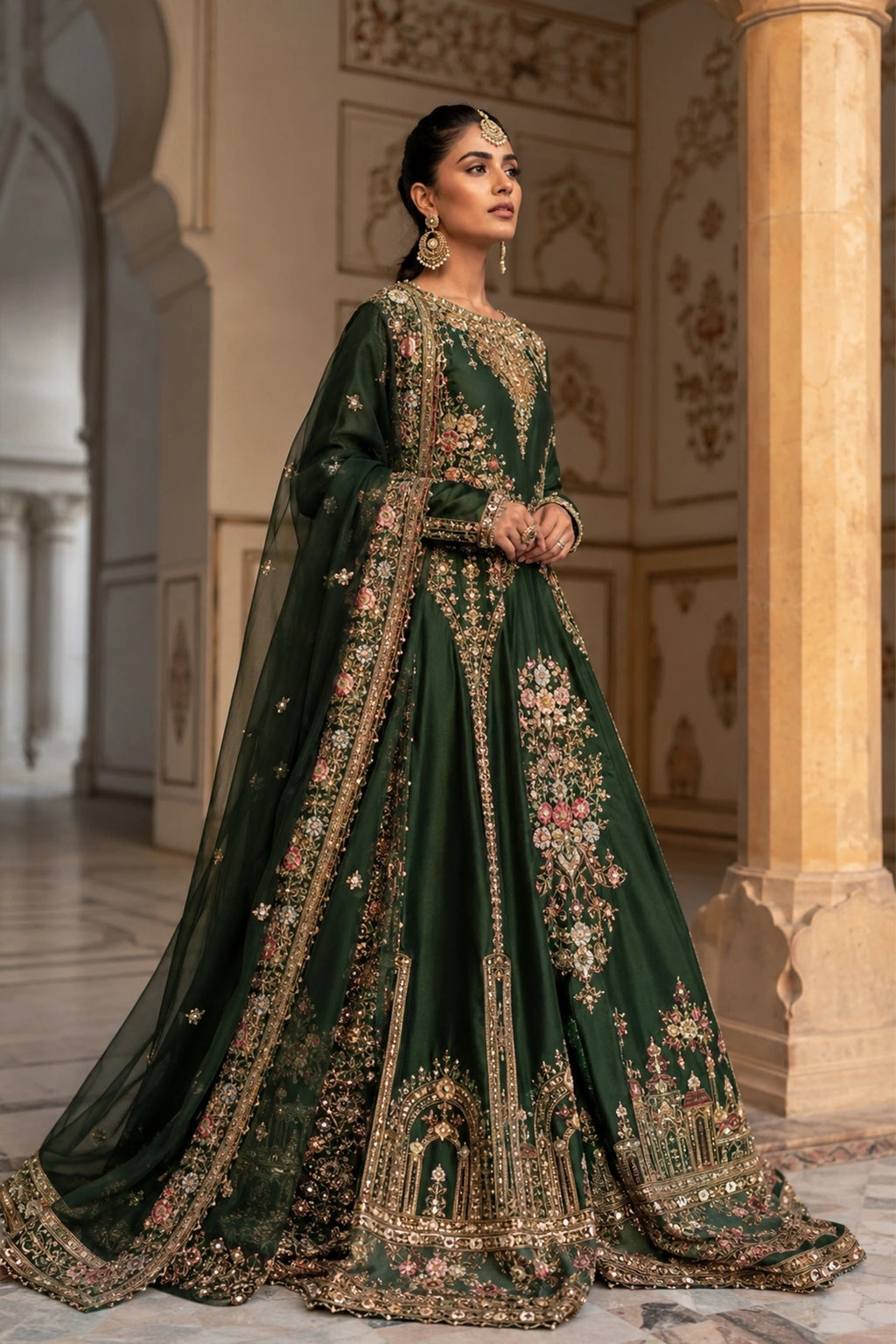 Woman wearing an emerald green raw silk pishwas with embroidered organza dupatta by Miraam