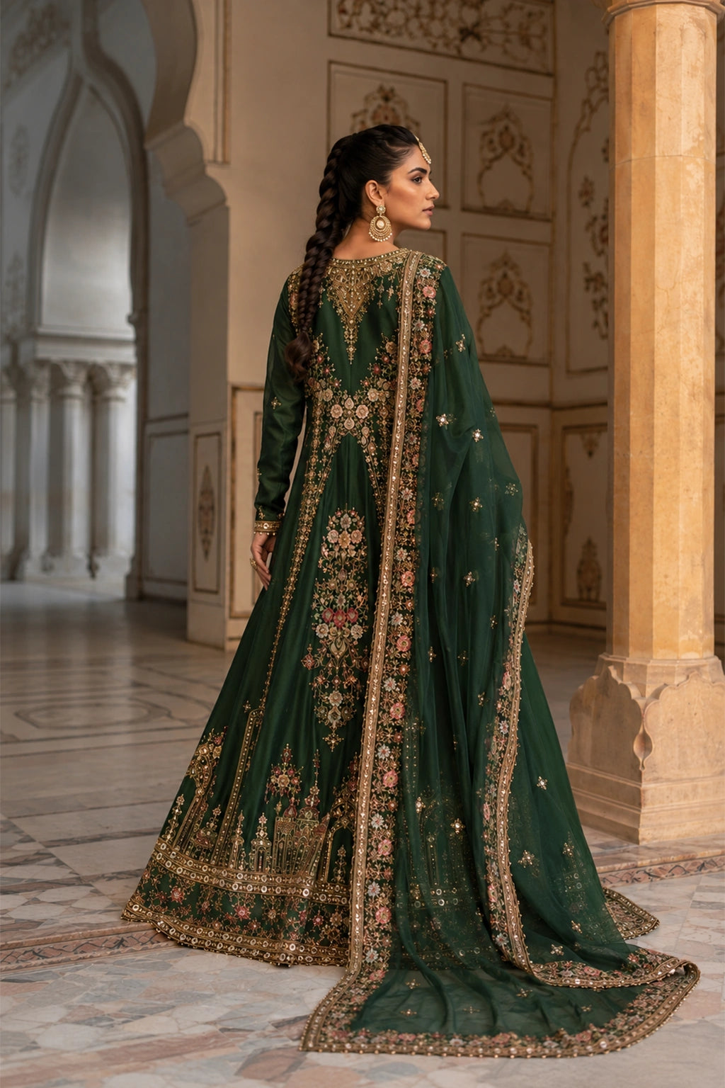 Woman wearing an emerald green raw silk pishwas with embroidered organza dupatta by Miraam