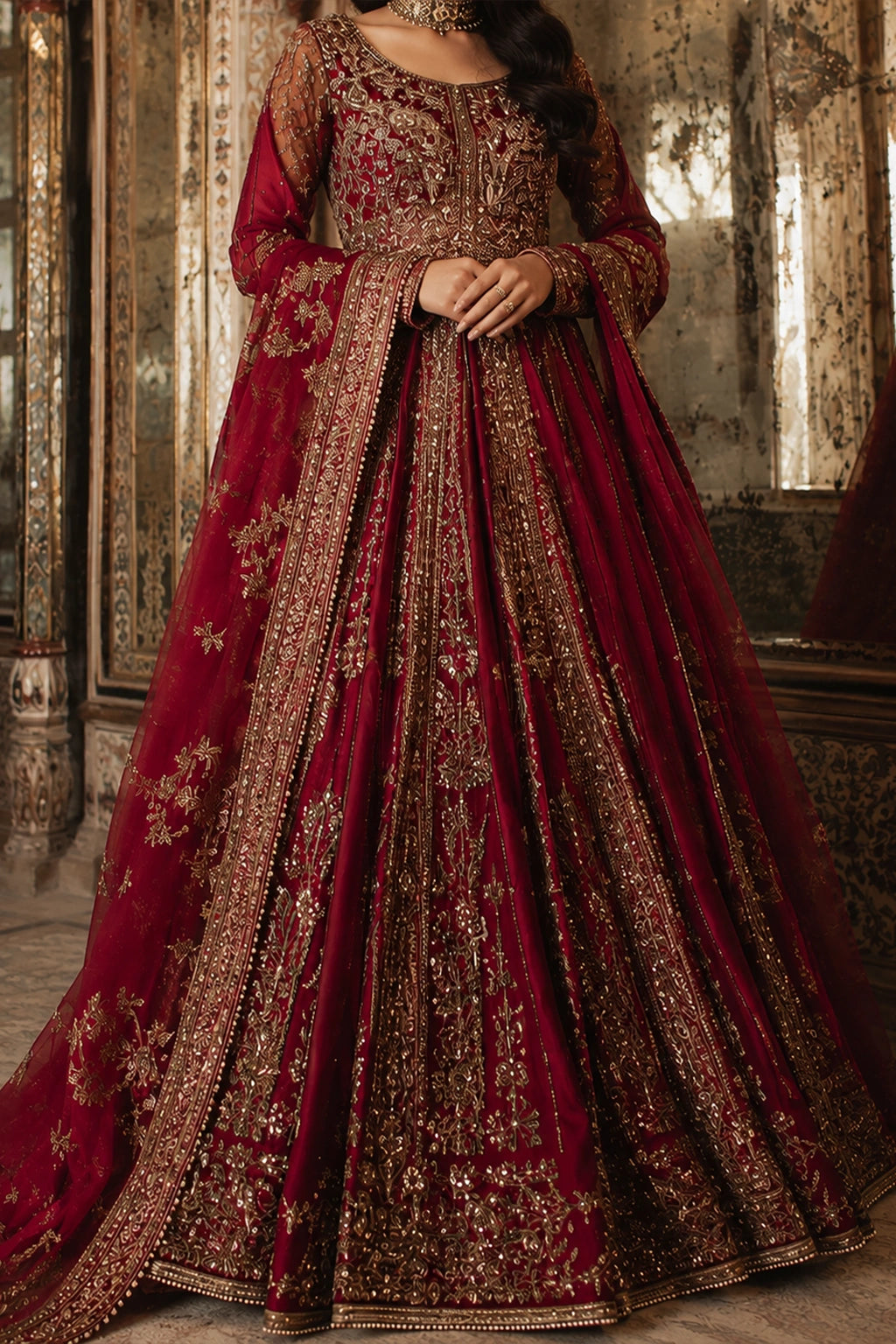 Woman wearing a deep ruby raw silk embellished pishwas with embroidered organza dupatta by Miraam