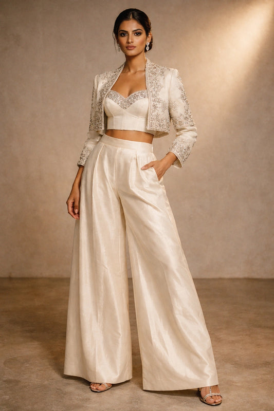 Ivory formal jacket and wide-leg pants set with embellished bustier by Miraam, styled in a luxury editorial setting