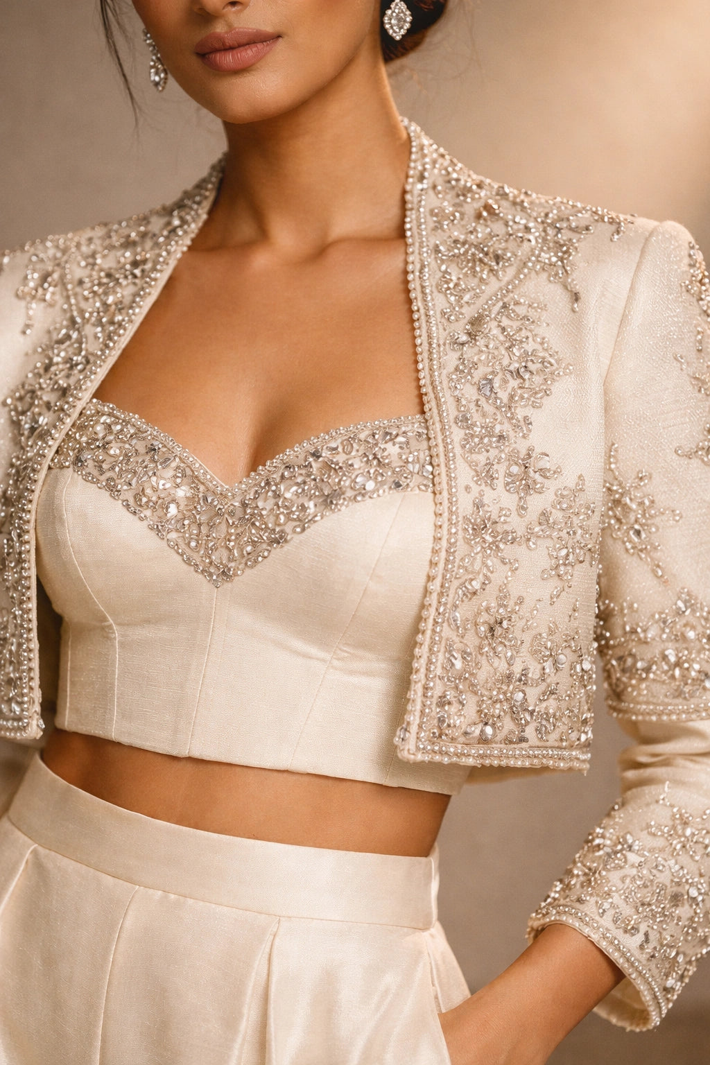 Ivory formal jacket and wide-leg pants set with embellished bustier by Miraam, styled in a luxury editorial setting