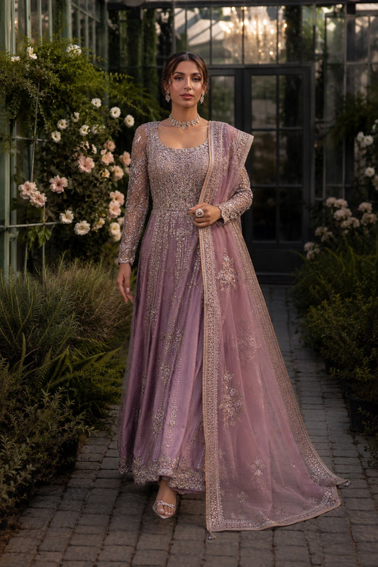Model wearing a mauve sheesha silk bridal pishwas with intricate embellishment and embroidered organza dupatta in a luxury garden-inspired setting by Miraam.
