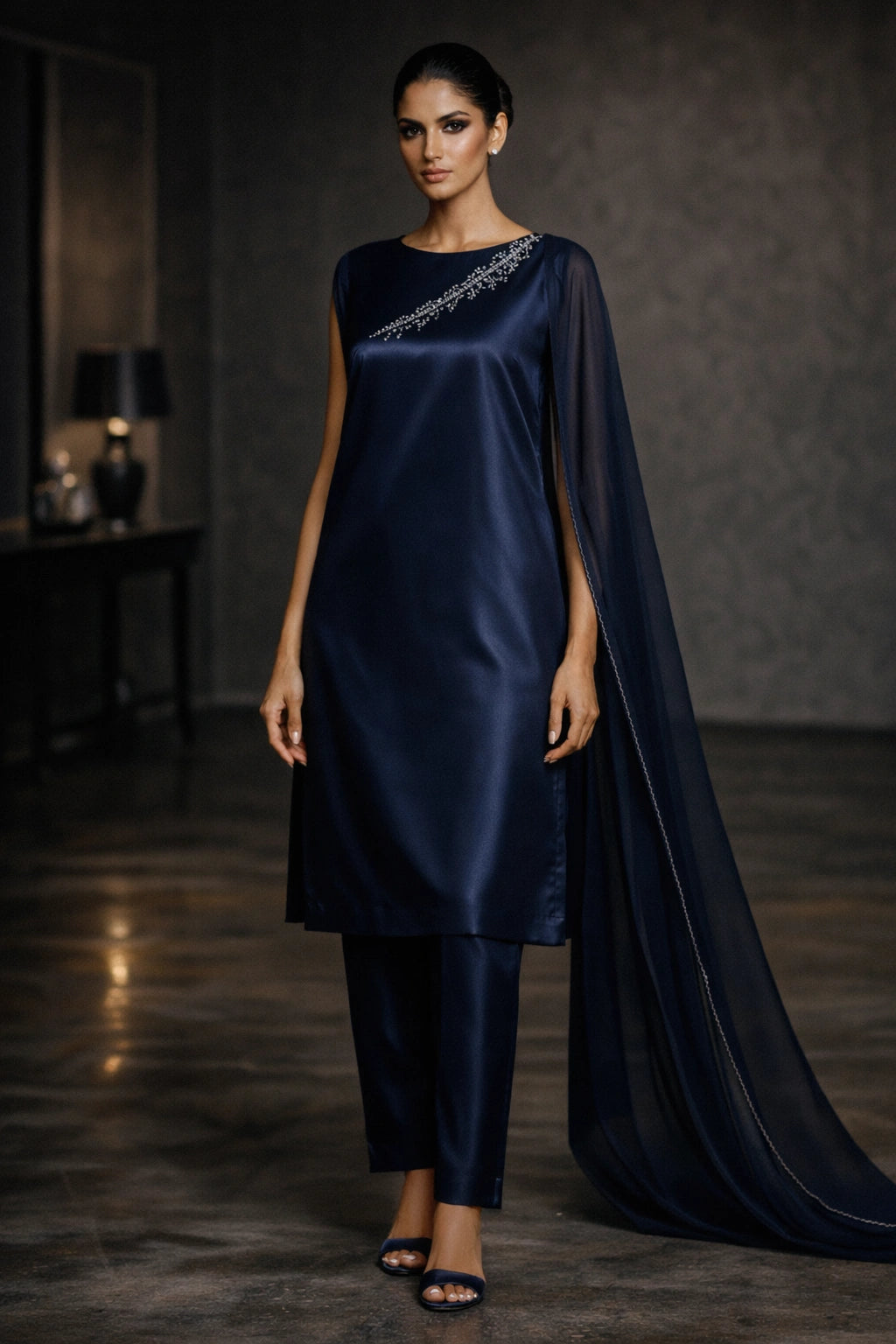 Deep navy sheesha silk outfit with minimal diagonal hand-embellished neckline and sheer dupatta from Miraam’s Noor-e-Sheesha Collection