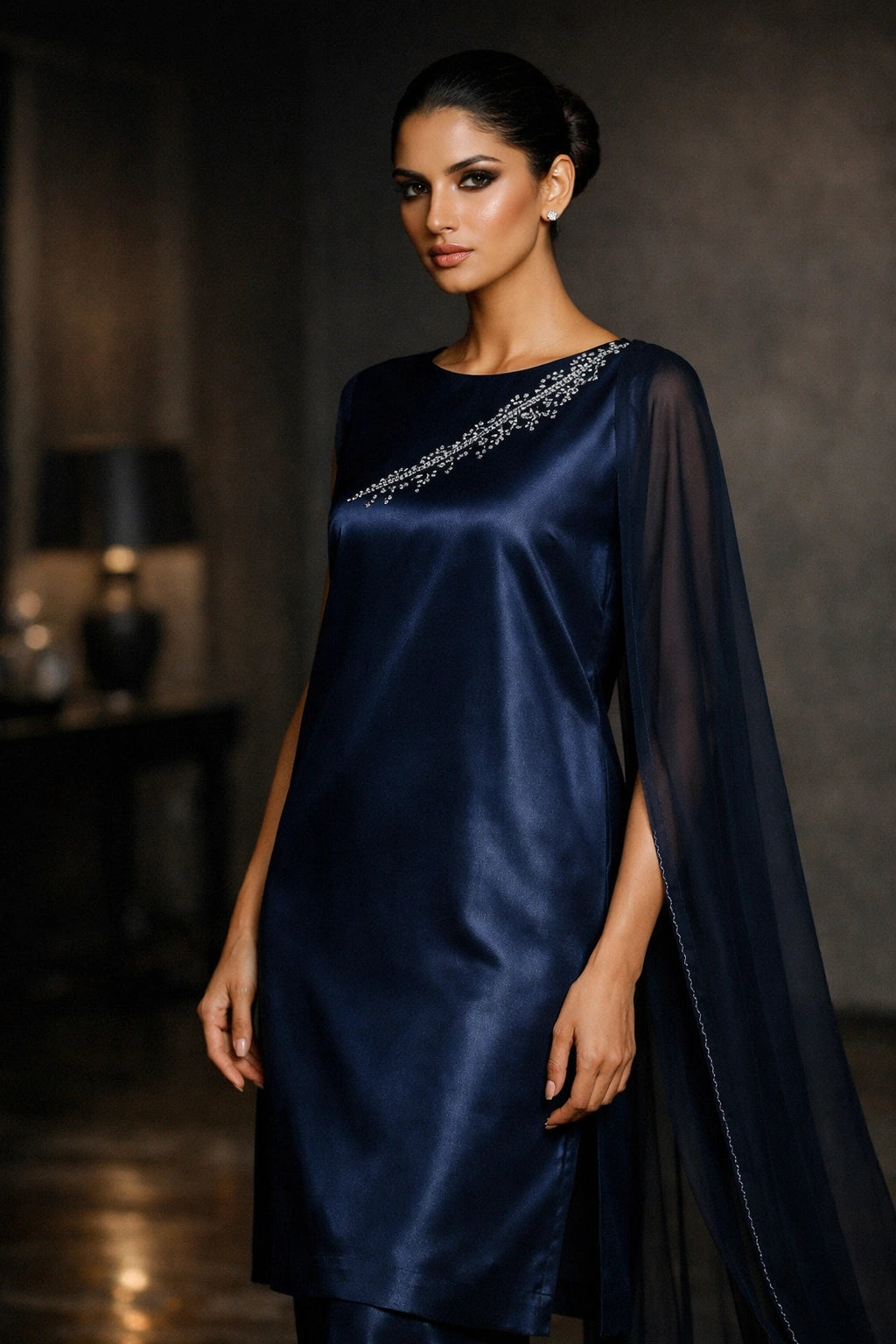 Deep navy sheesha silk outfit with minimal diagonal hand-embellished neckline and sheer dupatta from Miraam’s Noor-e-Sheesha Collection