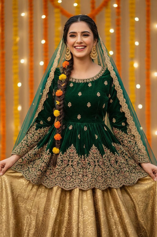 Emerald velvet festive ensemble featuring an embroidered short shirt, flowing lehenga, and sheer embroidered dupatta by Miraam.